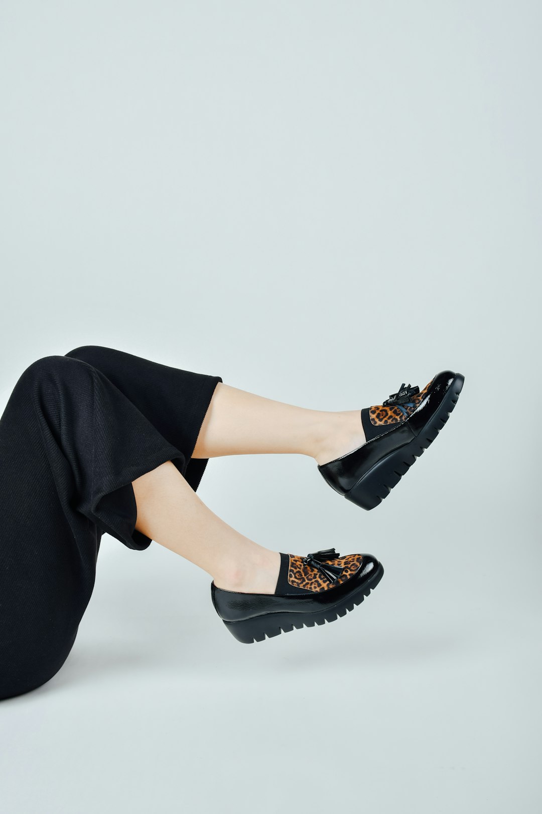 woman-in-black-pants-wearing-black-leather-peep-toe-heeled-shoes-88lnb7quiqo